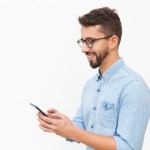 joyful guy texting message on smartphone